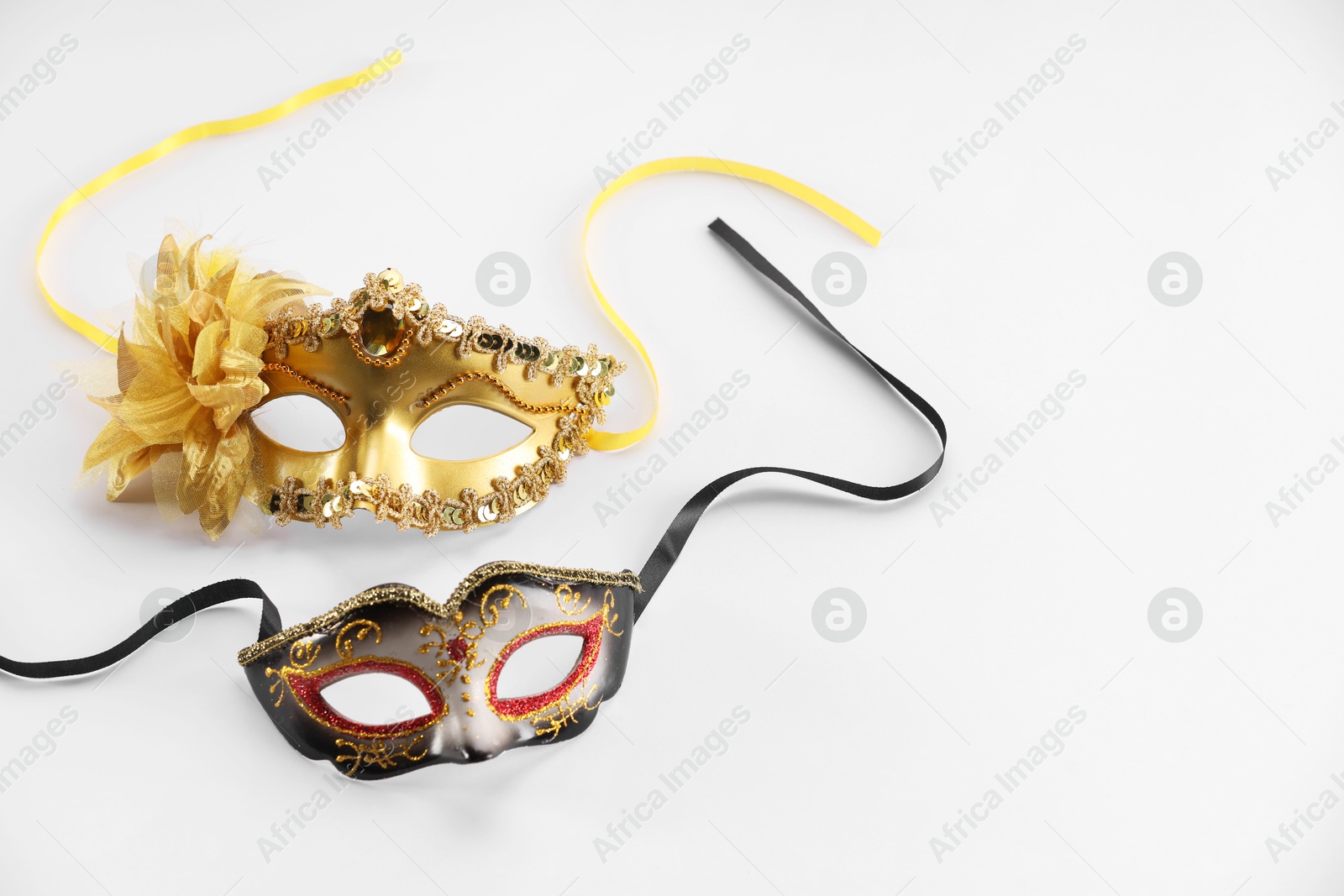 Photo of Elegant face masks on white background. Theatrical performance