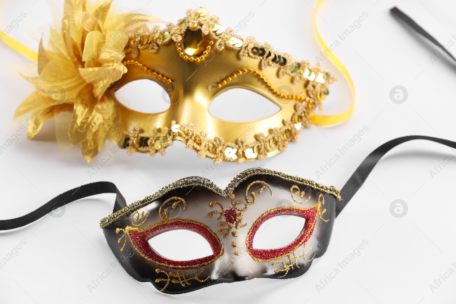 Photo of Elegant face masks on white background. Theatrical performance