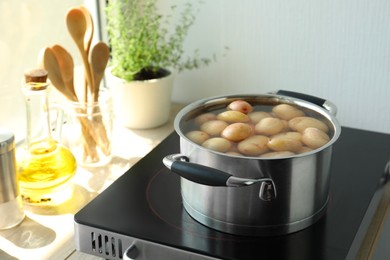 Boiling potatoes in pot on stove in kitchen