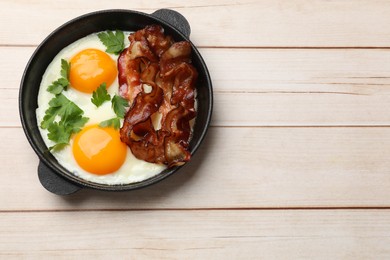 Photo of Tasty bacon, eggs and parsley on light wooden table, top view. Space for text