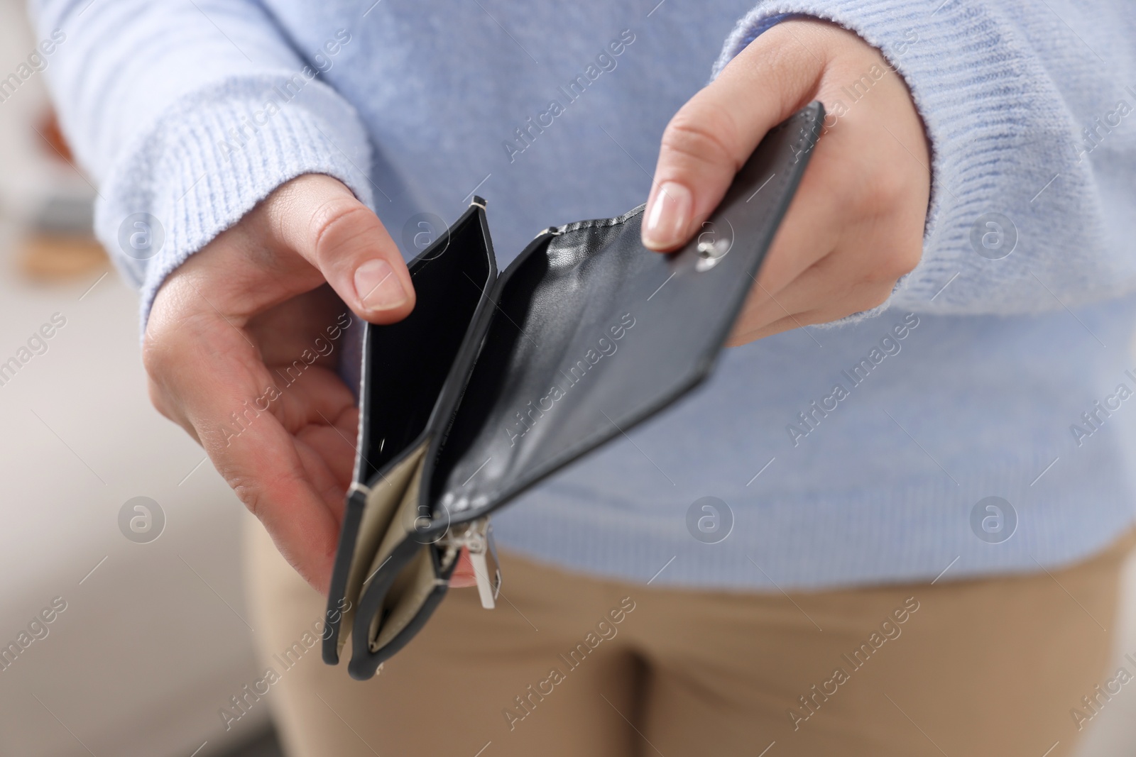 Photo of Woman with empty wallet indoors, closeup view