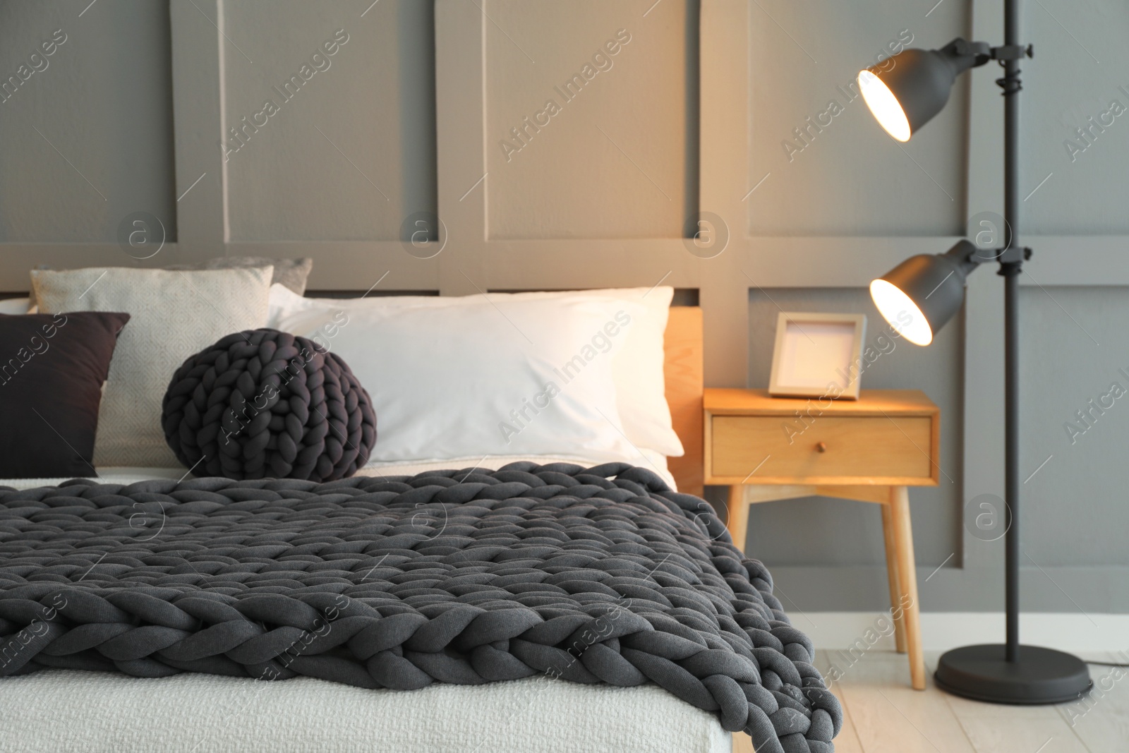 Photo of Stylish bedroom interior with comfortable bed and lamps