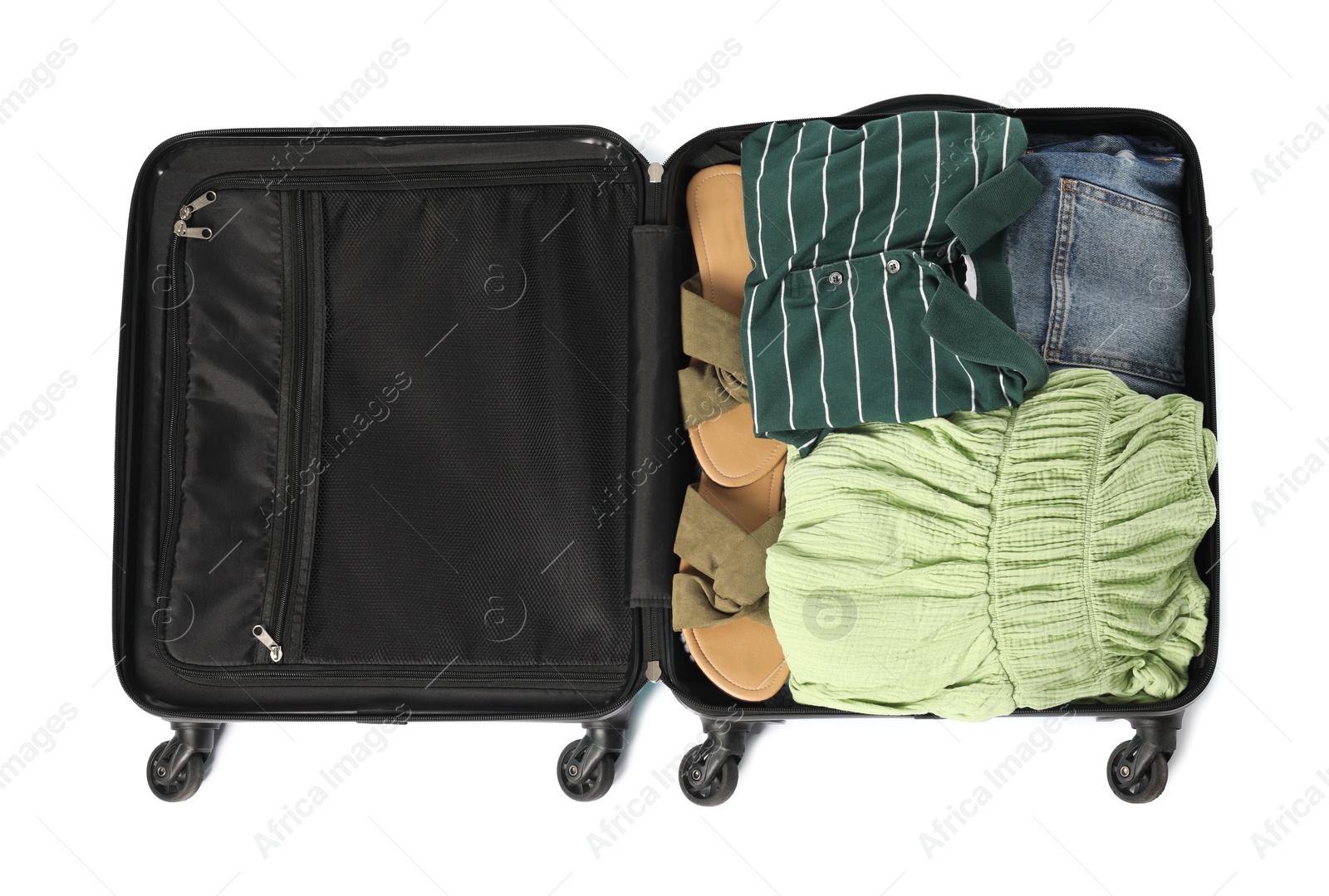 Photo of Open suitcase with clothes packed for travelling isolated on white, top view