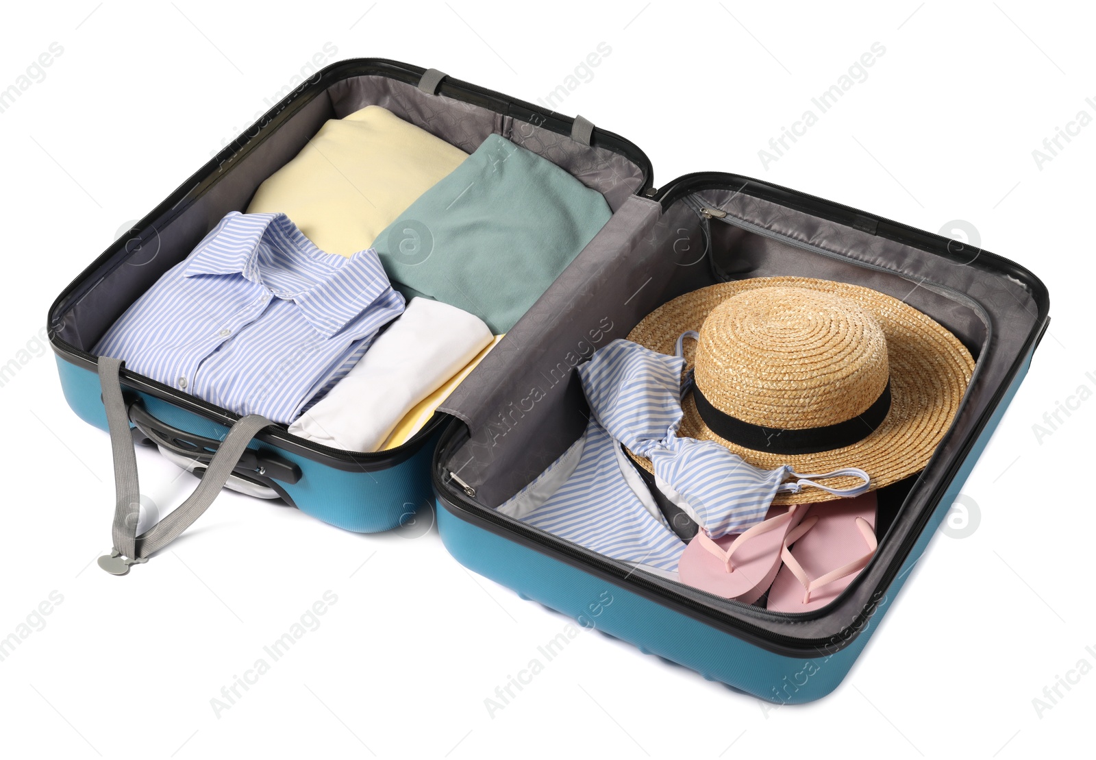 Photo of Open suitcase with clothes packed for travelling isolated on white