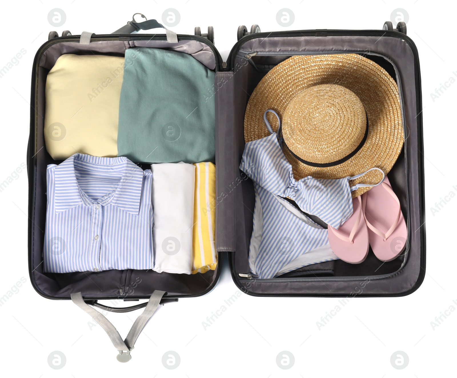 Photo of Open suitcase with clothes packed for travelling isolated on white, top view