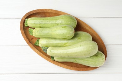 Photo of Raw green zucchinis on white wooden table, top view