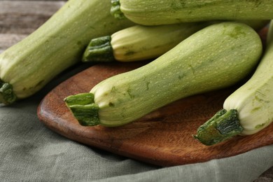 Photo of Raw ripe green zucchinis on table, closeup