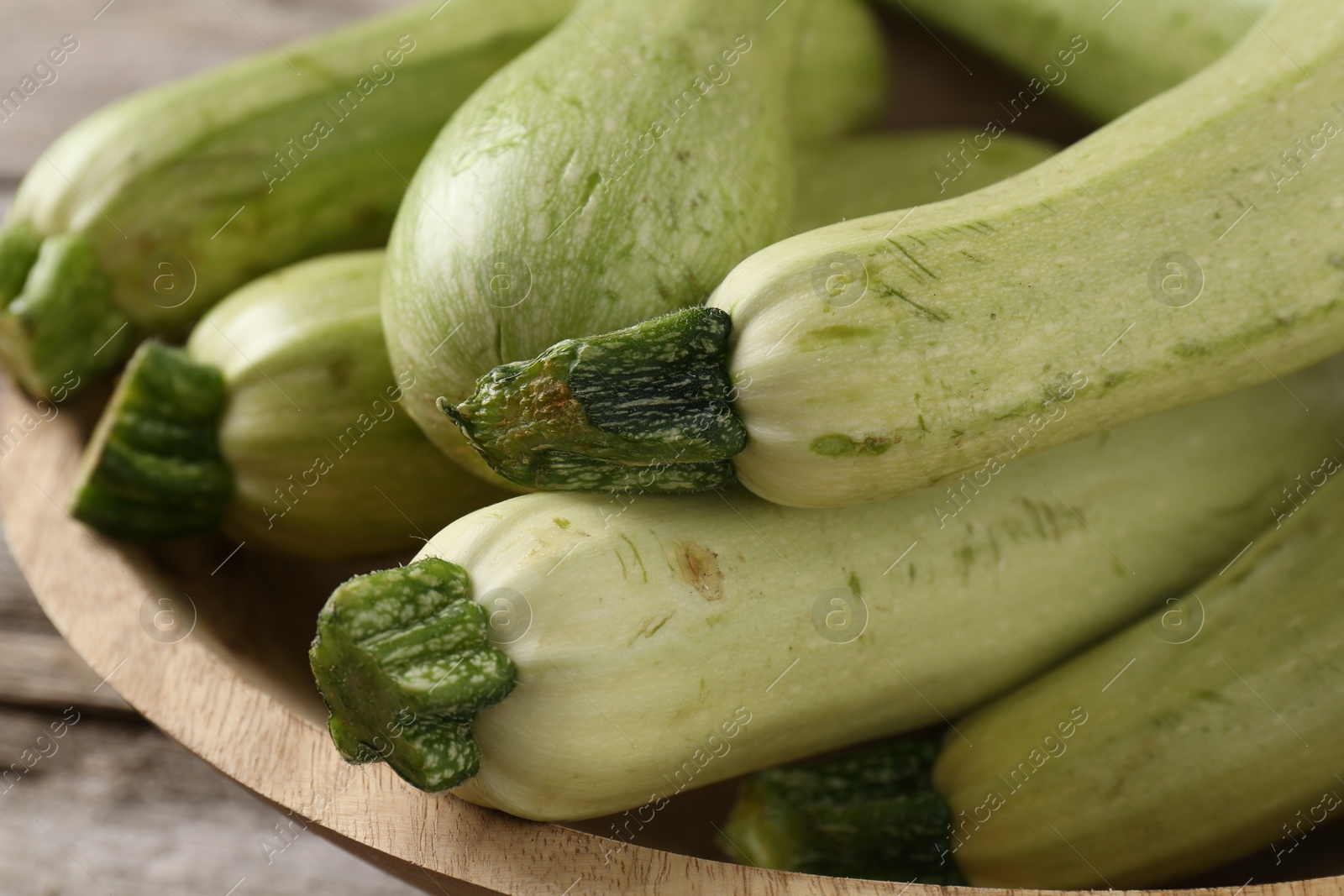 Photo of Raw ripe green zucchinis on table, closeup