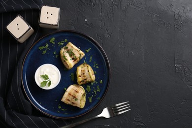 Tasty grilled zucchini slices served on grey textured table, flat lay. Space for text