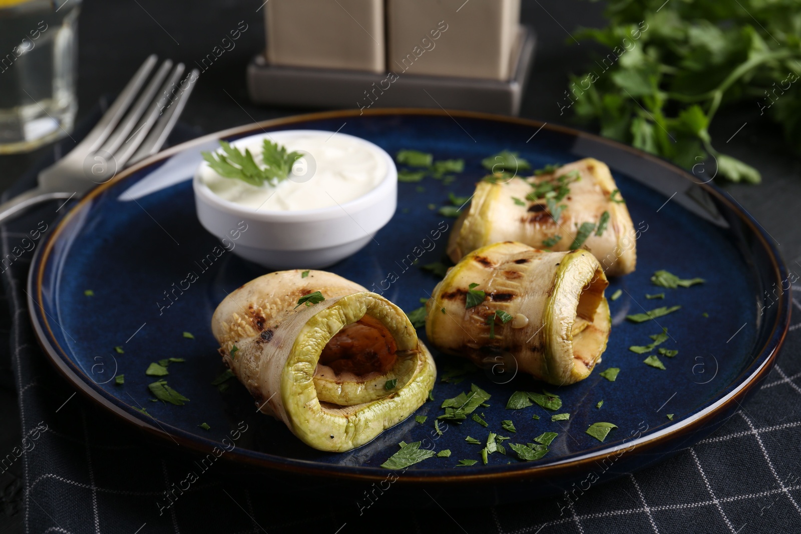 Photo of Tasty grilled zucchini slices served on grey table