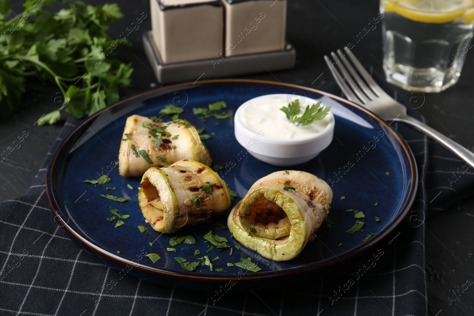 Photo of Tasty grilled zucchini slices served on grey table