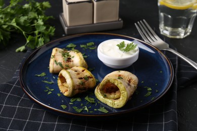 Tasty grilled zucchini slices served on grey table