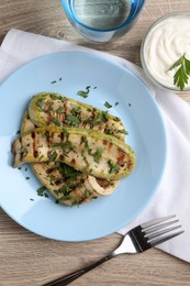 Photo of Tasty grilled courgette slices served on wooden table, flat lay