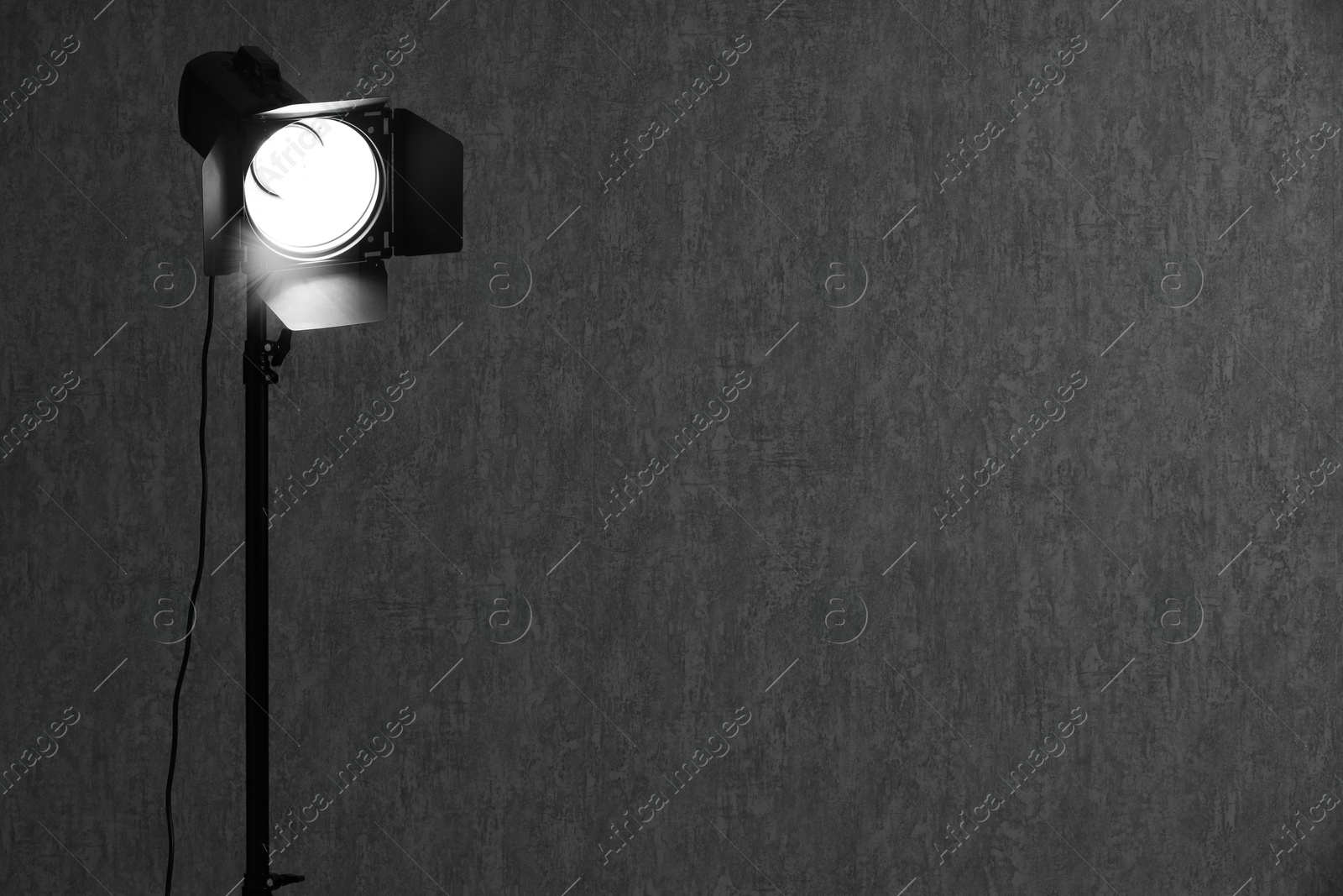 Photo of Dark photo background and professional lighting equipment in studio, space for text