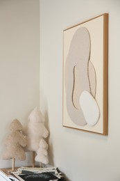 Photo of Frame with abstract artwork on wall and decorative elements in studio