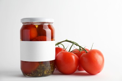 Photo of Tasty pickled tomatoes in jar and vegetables on light background, closeup