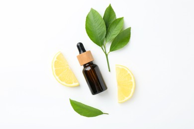 Photo of Bottle of essential oil, lemon and green leaves on white background, flat lay