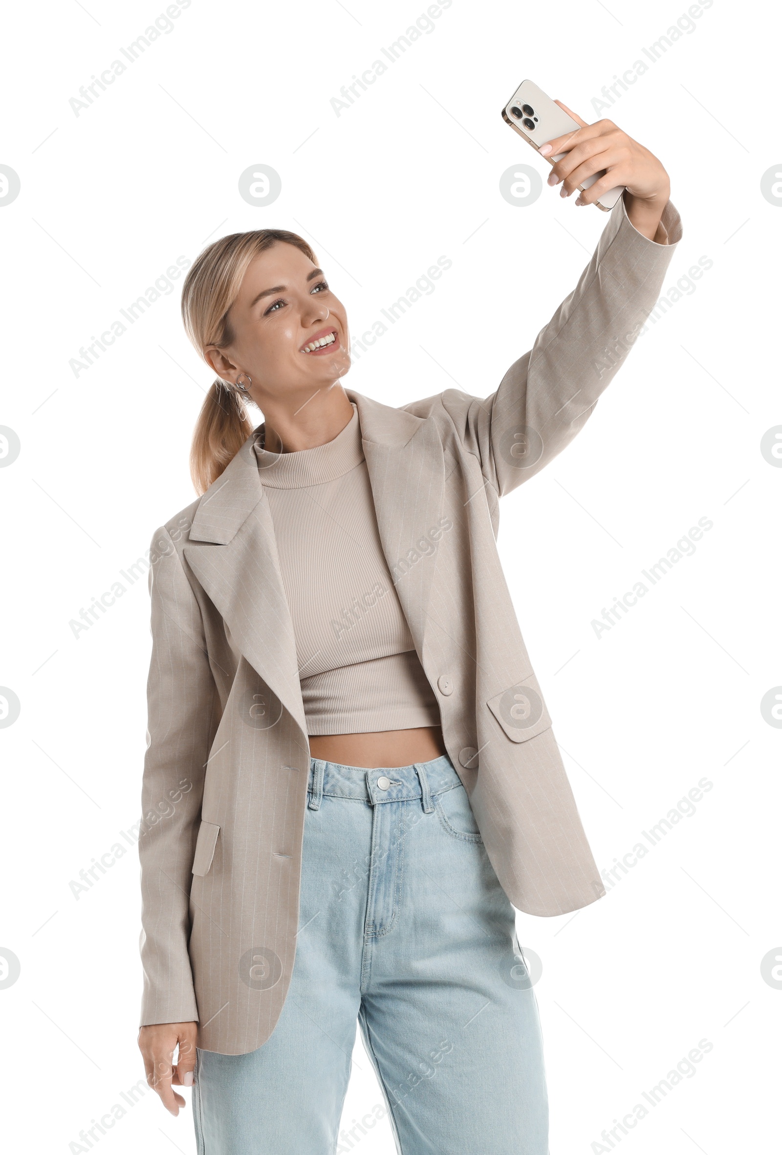 Photo of Beautiful woman in stylish jacket taking selfie on white background