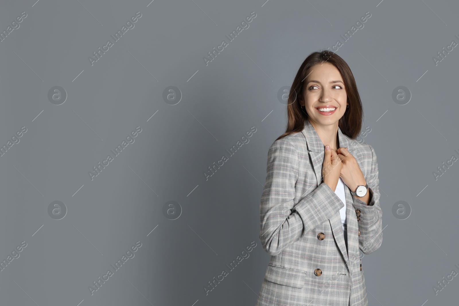 Photo of Beautiful woman in stylish jacket on grey background. Space for text