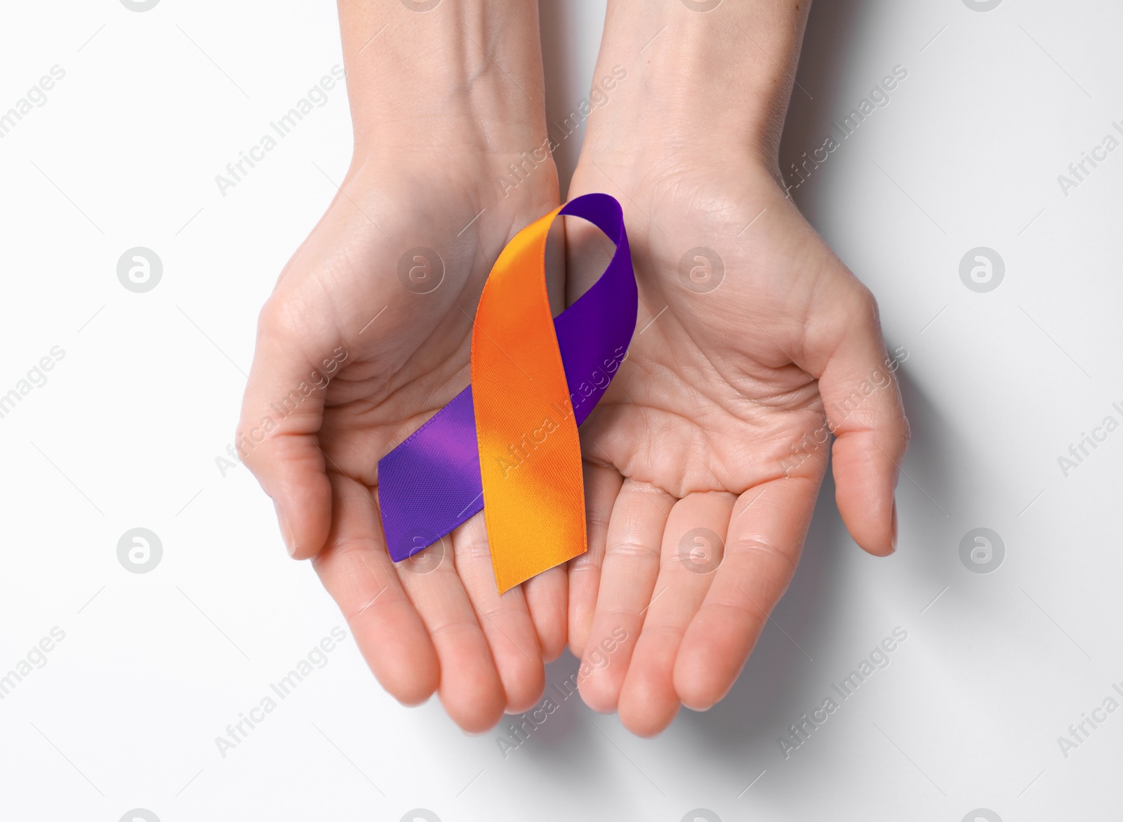 Image of World Psoriasis Day. Woman with orange and orchid ribbon as symbol of support on white background, top view