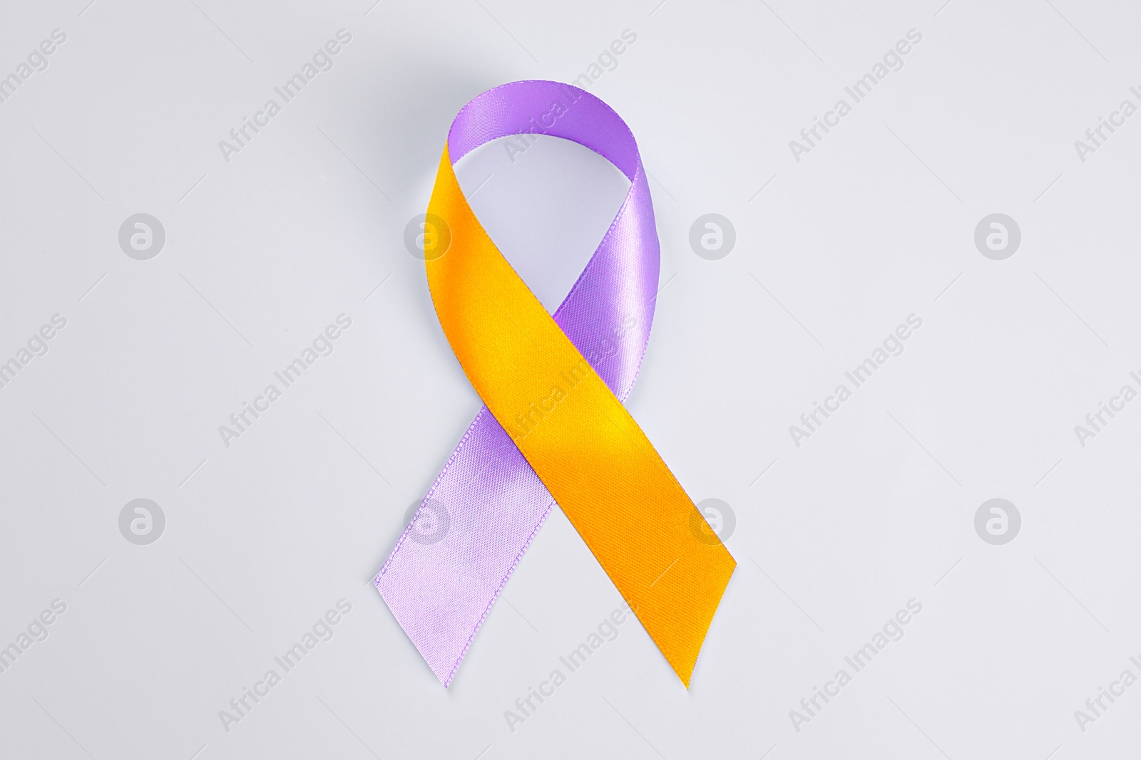 Image of World Psoriasis Day. Orange and orchid awareness ribbon as symbol of support on white background, top view