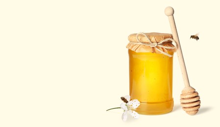 Image of Organic honey in glass jar, wooden dipper and bees on light background. Banner design with space for text