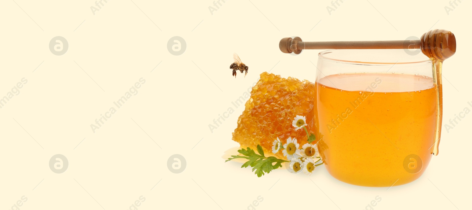 Image of Organic honey in glass jar, wooden dipper and honeycomb on beige background. Banner design with space for text