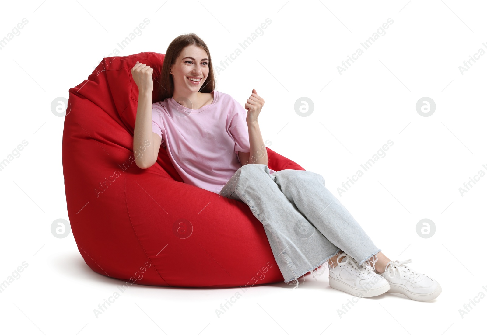 Photo of Smiling woman sitting on red bean bag chair against white background