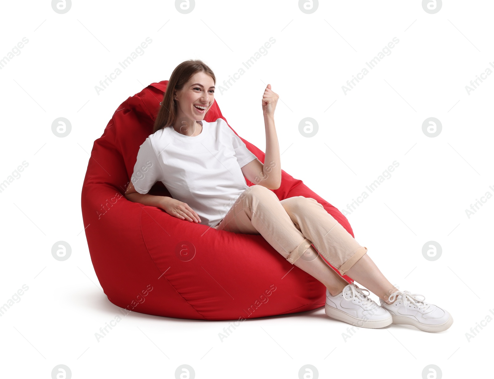 Photo of Happy woman sitting on red bean bag chair against white background