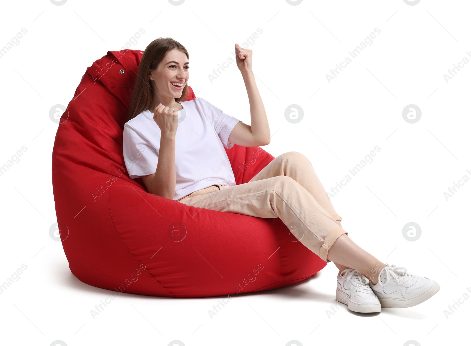 Photo of Smiling woman sitting on red bean bag chair against white background