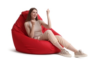 Photo of Smiling woman sitting on red bean bag chair against white background