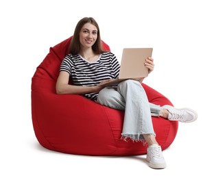 Smiling woman with laptop sitting on red bean bag chair against white background