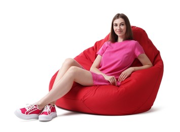 Photo of Beautiful young woman sitting on red bean bag chair against white background