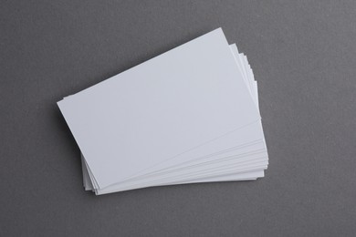 Blank business cards on grey background, top view. Mockup for design