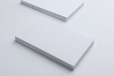 Blank business cards on light grey background. Mockup for design