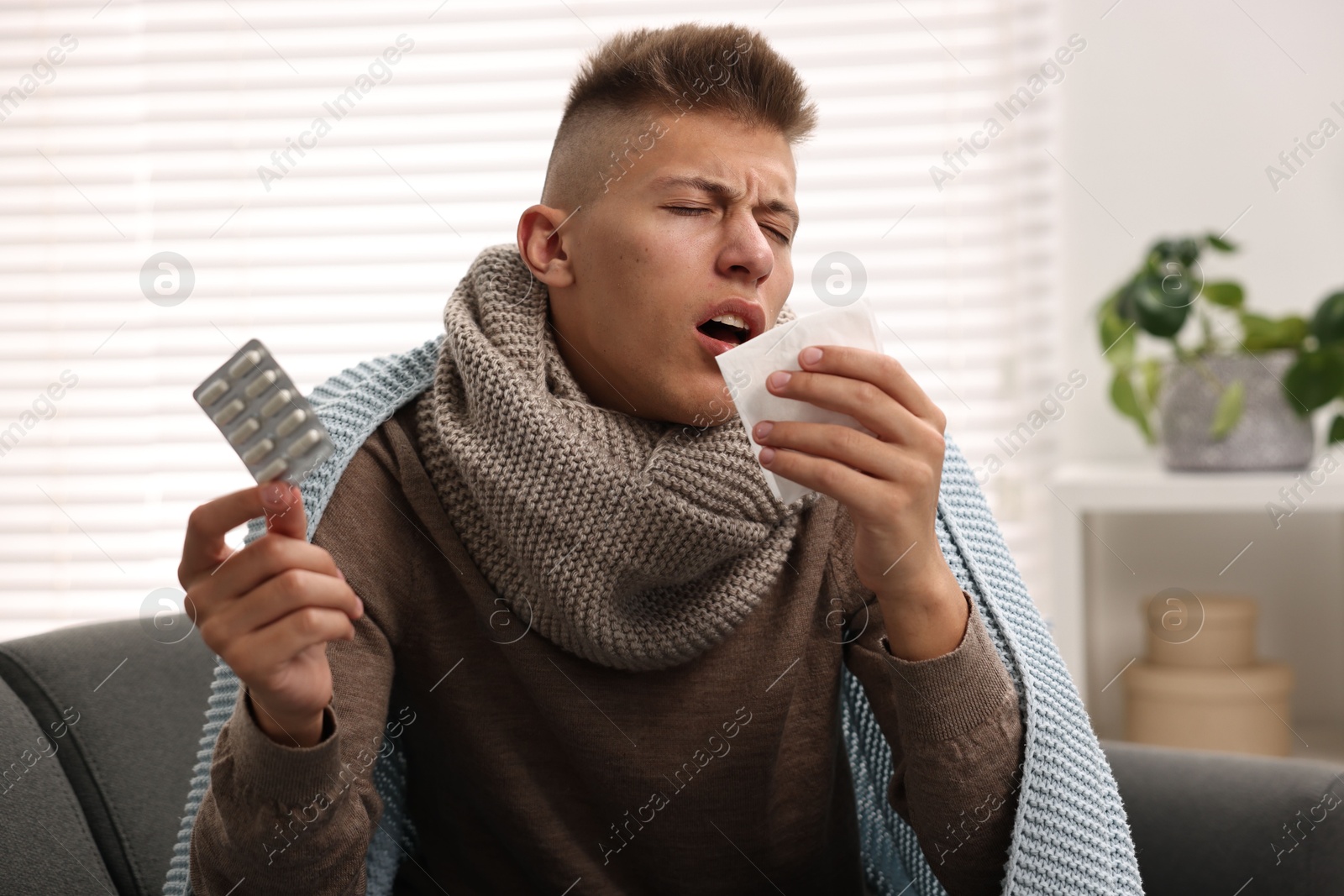 Photo of Cold symptom. Young man with runny nose at home