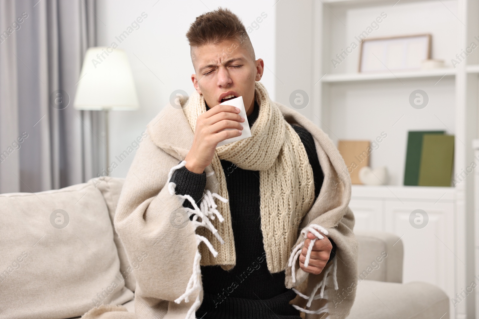 Photo of Cold symptom. Young man with runny nose at home