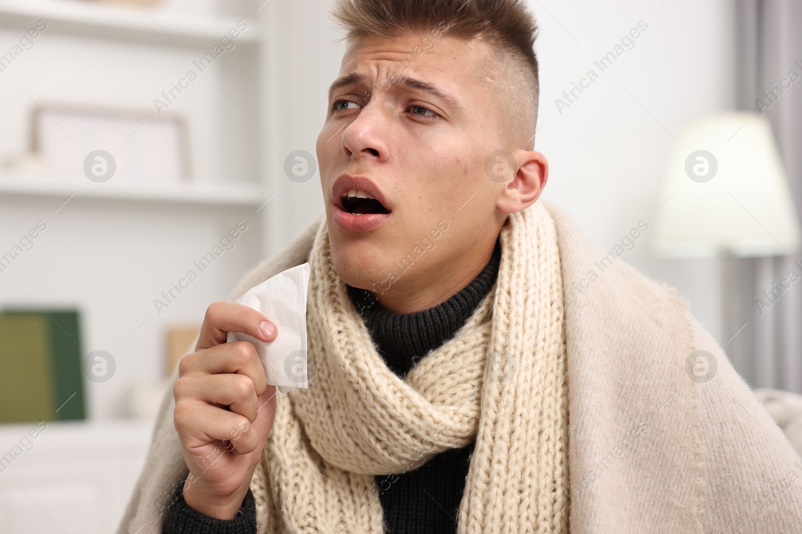 Photo of Cold symptom. Young man suffering from fever at home