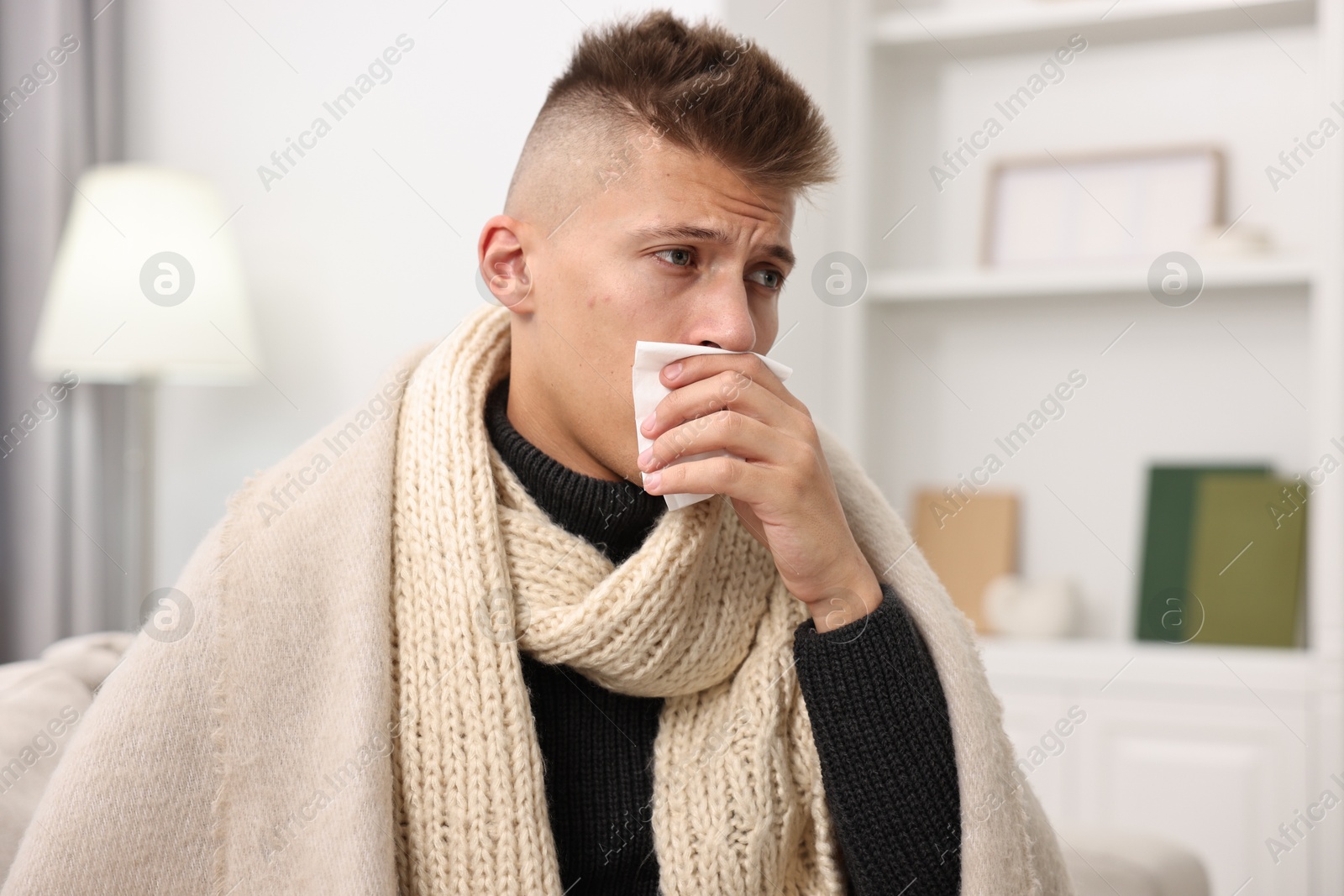 Photo of Cold symptom. Young man suffering from fever at home