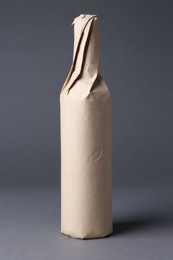 One wine packed bottle on grey background