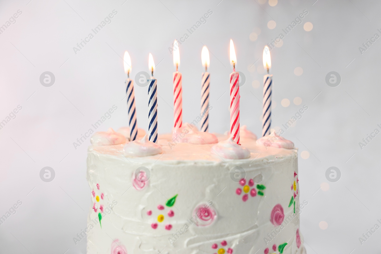 Photo of Tasty Birthday cake with burning candles against light grey background, closeup