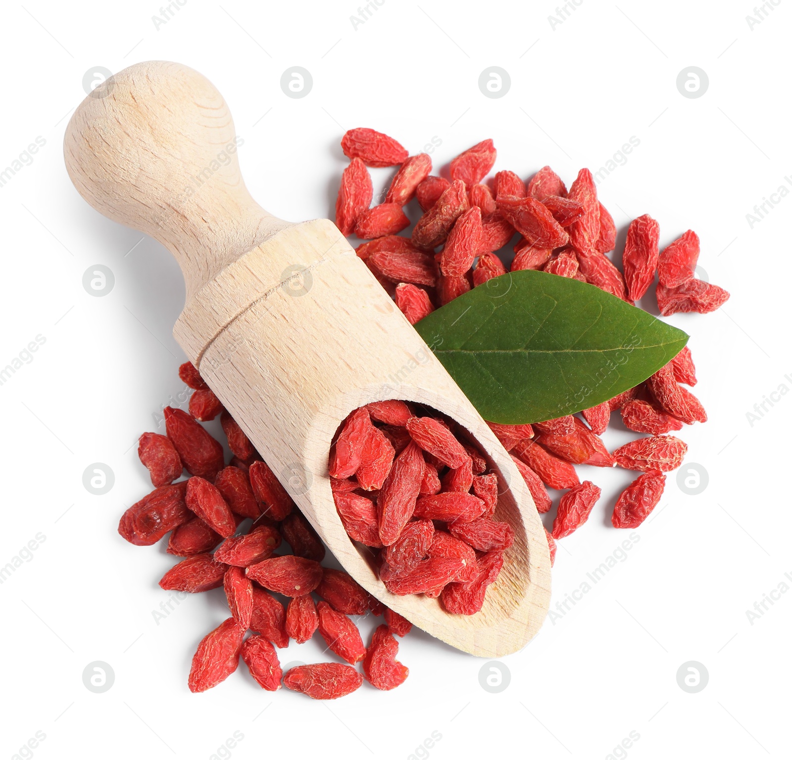 Photo of Dried goji berries, green leaf and wooden scoop isolated on white, top view