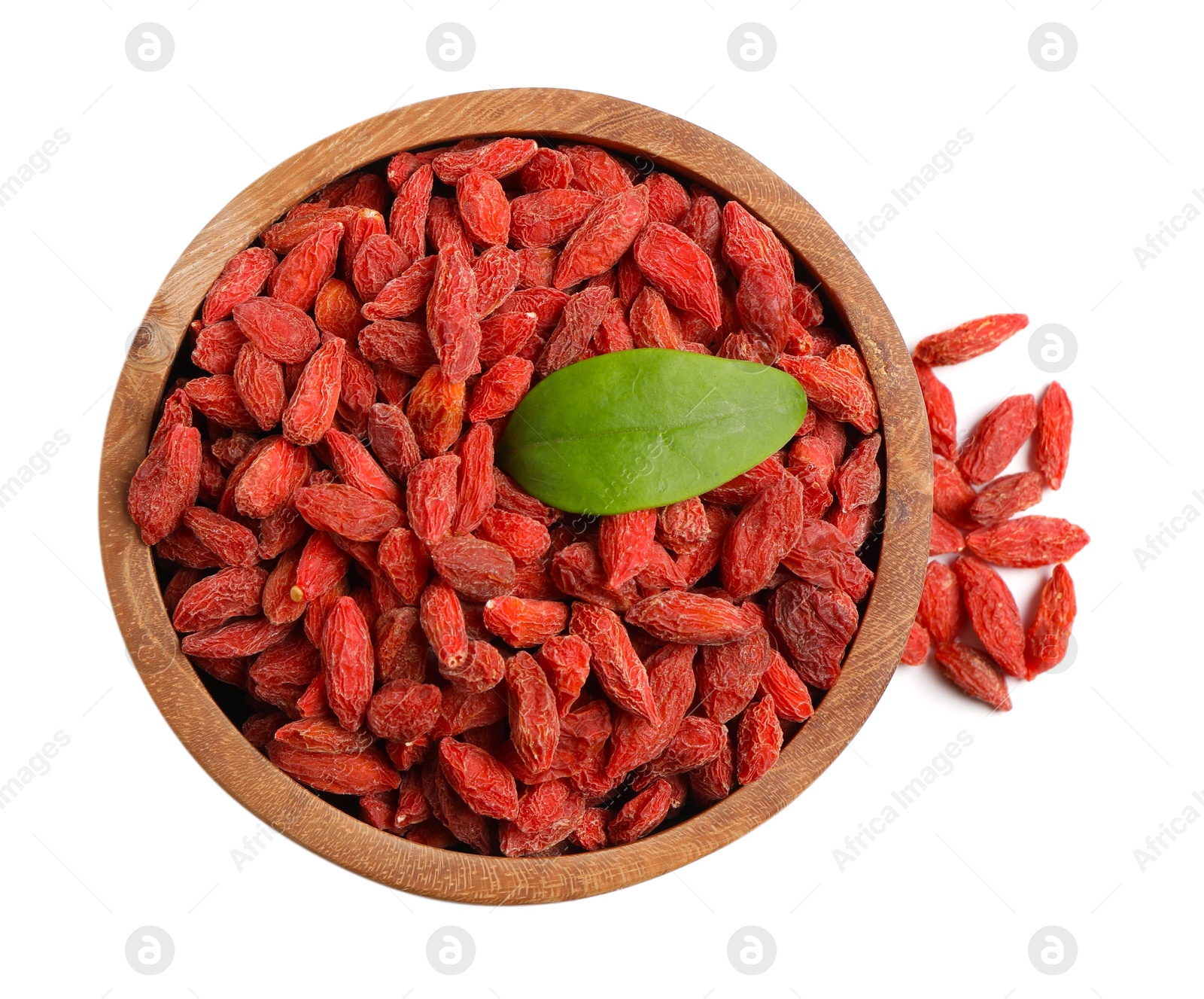 Photo of Dried goji berries and leaf in bowl isolated on white, top view