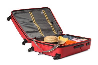 Photo of Open suitcase with clothes packed for travelling isolated on white