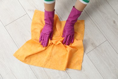 Woman cleaning floor with rag, above view