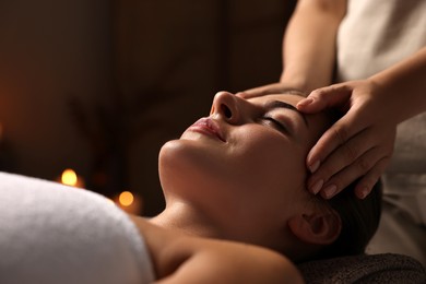 Photo of Attractive woman enjoying face massage, closeup. Beauty procedure