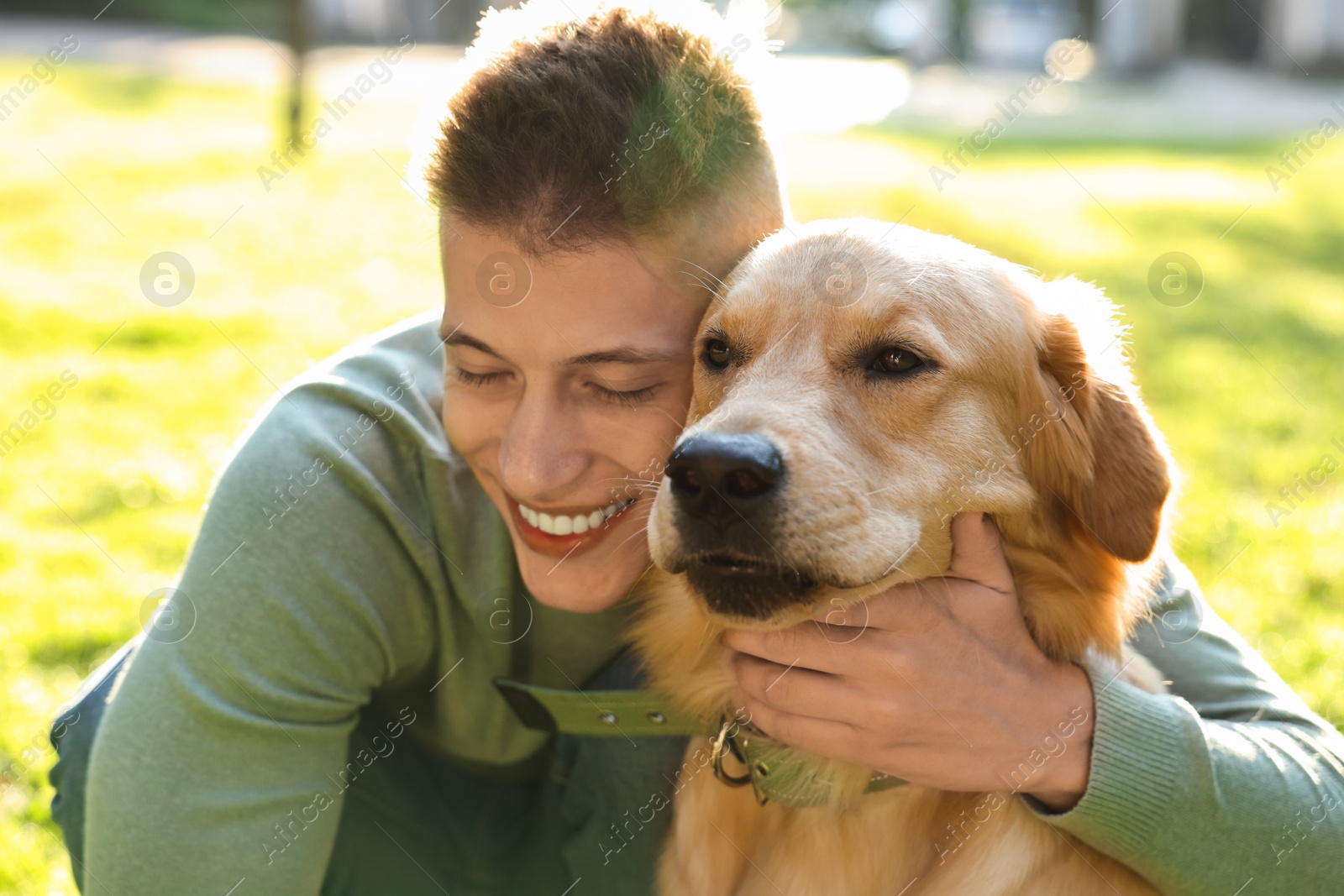 Photo of Young man with his lovely dog in park on sunny day