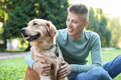 Photo of Young man with his lovely dog in park