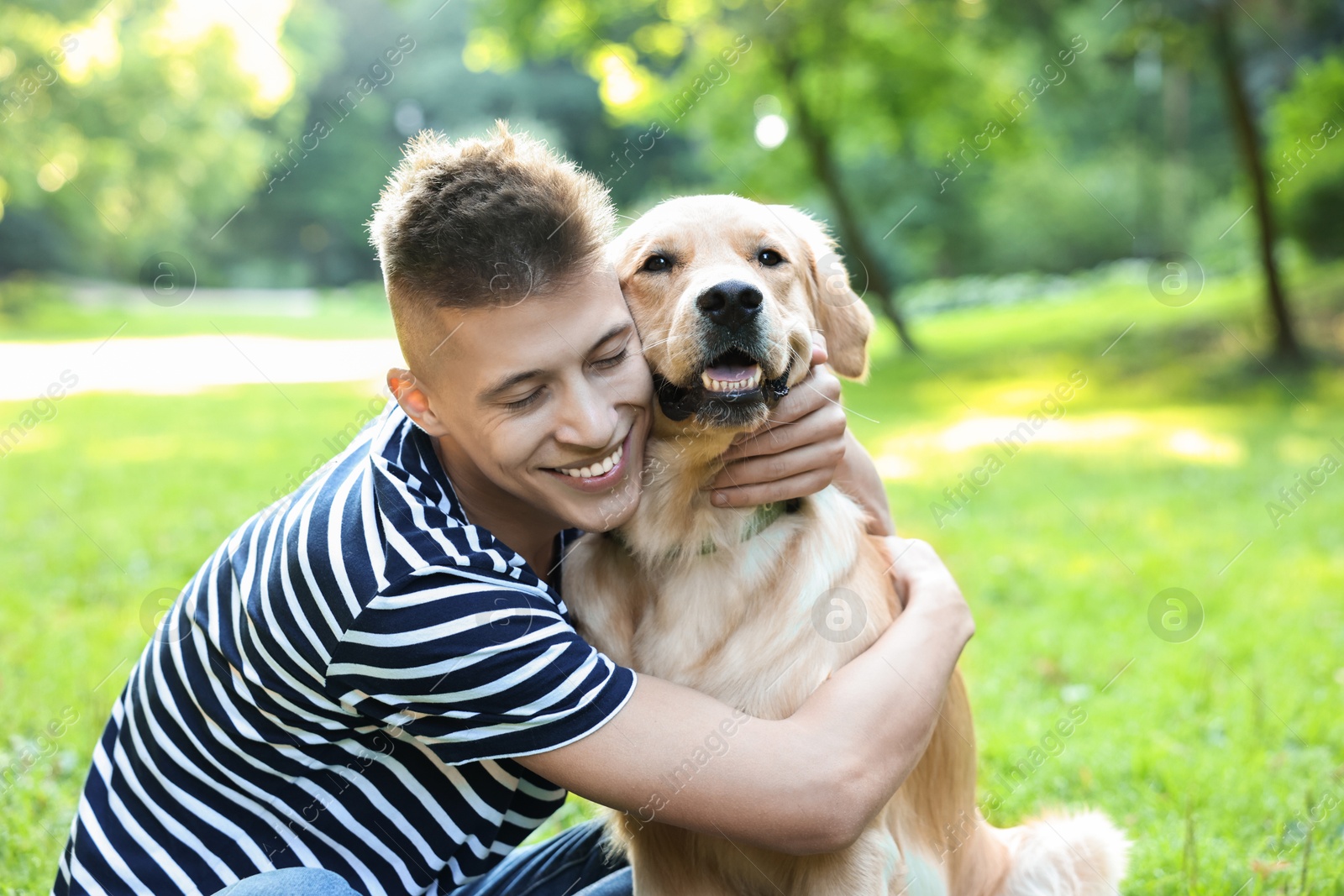 Photo of Young man with his lovely dog in park