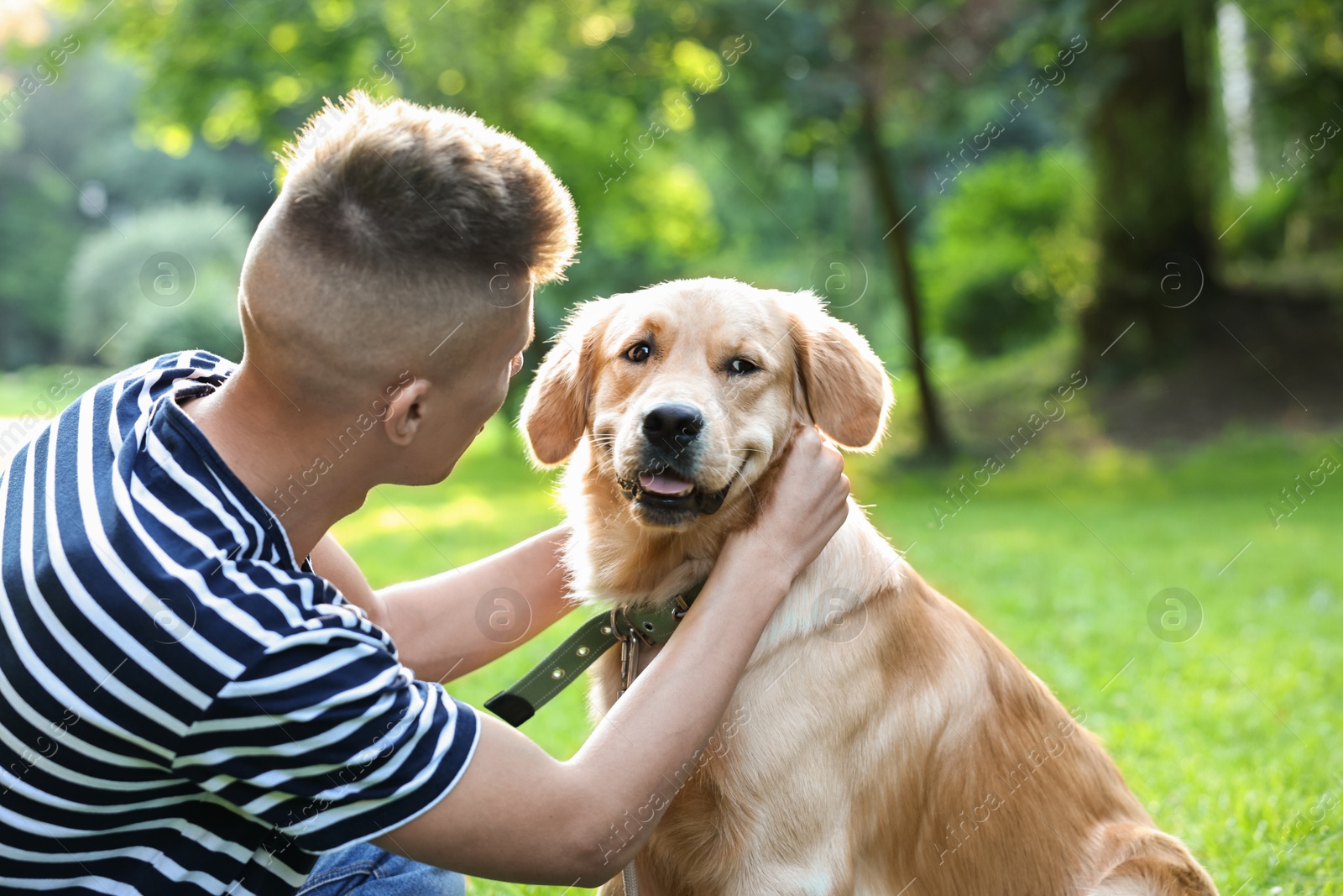 Photo of Young man with his lovely dog in park